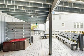 A covered outdoor deck with benches and a storage unit. - Waccamaw Condo - Unit 6 (Murrells Inlet)