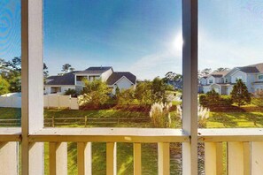 Um bairro residencial com casas, gramado e cerca de madeira.
