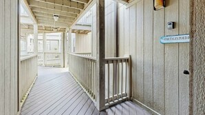 A wooden corridor with a sign reading 'FISH TALESTOIL.' - Dunes Pointe Unit B-11 (Myrtle Beach)