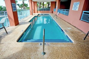 A swimming pool with a no diving sign, a lifeguard duty sign, and a no diving allowed sign. - Roxanne Towers Unit PH1 (Myrtle Beach)