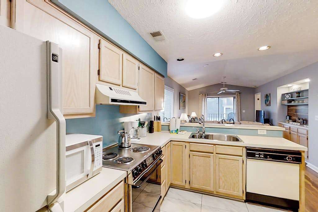A kitchen with a microwave, stove, and dishwasher.