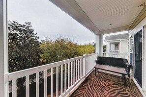 A covered porch with a white railing, a bench, and a patterned floor. - 1033 World Tour Unit 306 (Myrtle Beach)