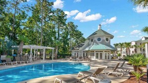 A pool area with lounge chairs and a gazebo. - 1033 World Tour Unit 306 (Myrtle Beach)