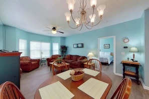 A spacious living room with a dining area, a chandelier, and a ceiling fan. - Homey Beach Hideaway C (Myrtle Beach)