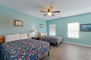 A bedroom with two beds, a ceiling fan, and two windows with blinds. - Homey Beach Hideaway C (Myrtle Beach)