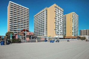 A multi-story hotel with balconies, a beachside location, and a clear sky. - Sands Ocean Club 1629 (Myrtle Beach)