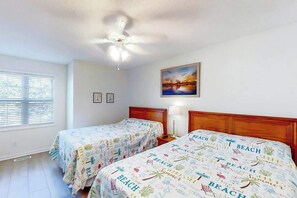 A hotel room with two beds, a ceiling fan, a window with blinds, and a painting on the wall. - Fairway Oaks Unit 24B (North Myrtle Beach)