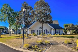A residential house with a front yard, a driveway, and a street lamp. - Fairway Oaks Unit 24B (North Myrtle Beach)