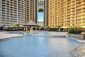 A swimming pool area with a gazebo, surrounded by high-rise residential buildings. - Barefoot Livin' Retreat (North Myrtle Beach)