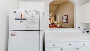 A kitchen with a white refrigerator, a white countertop, and a white cabinet. - Cypress Bend Unit 434 (North Myrtle Beach)