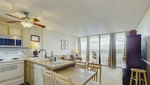 A kitchen with a dining area, a ceiling fan, and a view to the outside. - Royal Gardens Beach Front Condominium (Murrells Inlet)