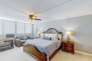 A bedroom with a bed, bedside tables, a desk, and a ceiling fan. - Shoreham Towers Unit 3-B (North Myrtle Beach)
