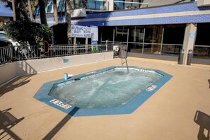 A swimming pool with a sign indicating no lifeguard on duty and no diving allowed. - Sunny and Ready Retreat (Myrtle Beach)