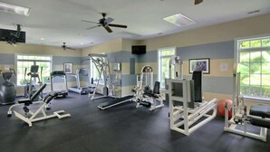 A gym with various exercise equipment, ceiling fans, and windows. - Tupelo Bay, Unit 1514 (Murrells Inlet)