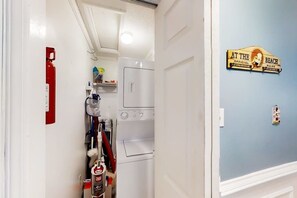 A laundry room with a washing machine, dryer, and a fire extinguisher. - Windy Village Unit C-2 (North Myrtle Beach)