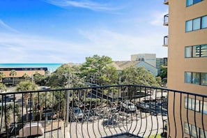 A balcony with a view of a parking area and buildings, overlooking a body of water. - Tuscan Ocean Vista, Unit D (Myrtle Beach)