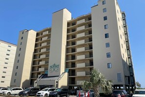 A multi-story hotel with a central entrance and balconies on each floor. - The Summit Unit 2-A Condo (North Myrtle Beach)