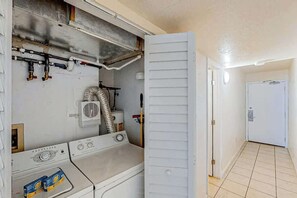 A laundry room with a washing machine, dryer, and ventilation system. - Water's Edge Luxe | Nine Oh One (Murrells Inlet)