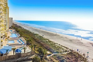 A resort with multiple swimming pools, a beach, and a high-rise building. - Bay Watch Resort 1901 Oceanview (North Myrtle Beach)