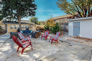 A backyard with outdoor seating, a fire pit, and a garage. - Flamingo House 2 - top (North Myrtle Beach)