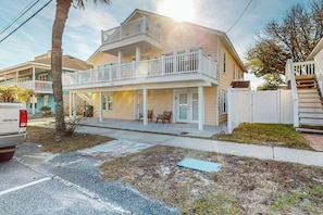 A two-story residential building with a balcony, a front porch, and a garage. - Flamingo House 2 - top (North Myrtle Beach)