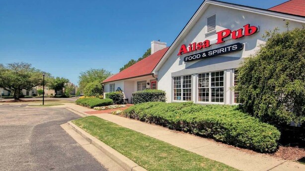 A building with a sign reading 'Ails Pub Food & Spirits' on the front. - Legends Resort at Myrtle Beach Unit F (Myrtle Beach)