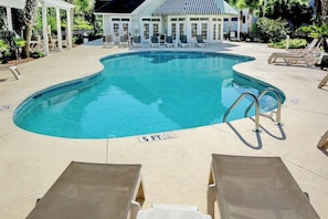 A swimming pool with lounge chairs and a covered seating area. - 1009 World Tour Unit 306 (Myrtle Beach)