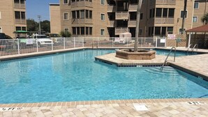 A swimming pool with a white fence, a lifeguard stand, and a sign indicating a 3 ft depth. - Waipani Unit D-12 Condo (North Myrtle Beach)