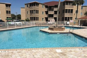 A swimming pool with a white fence, a lifeguard stand, and a sign indicating a 3 ft depth. - Waipani Unit D-12 Condo (North Myrtle Beach)