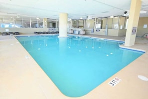 An indoor swimming pool with clear water, a 3ft depth marker, and a tiled floor. - North Beach Villas 201 (North Myrtle Beach)