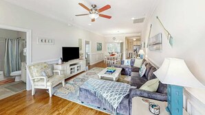 A spacious living room with a television, sofa, and coffee table. - A Shore Pleasure Retreat (North Myrtle Beach)