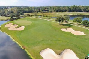 A golf course with bunkers, water hazards, and trees. - Catalina Cove Retreat (North Myrtle Beach)