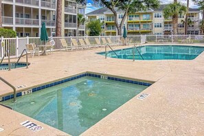 A swimming pool with a 1-foot depth marker, surrounded by lounge chairs and a white fence. - Ocean Keyes 3722 The Gleaming Starfish (North Myrtle Beach)