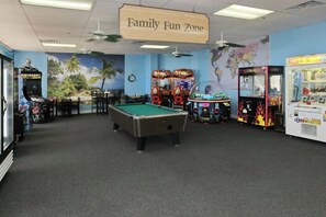 A Family Fun Zone with a pool table, arcade games, and a world map mural. - The Golden Sailboat B-139 (Myrtle Beach)
