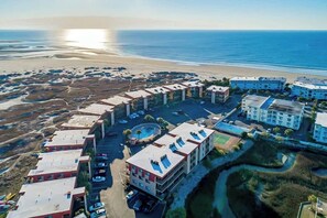 An aerial view of a coastal hotel with multiple buildings, a swimming pool, and a beach in the background. - Inlet Point Villas 10-D (North Myrtle Beach)