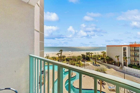 A balcony with a view of a swimming pool, beach, and ocean. - Sand Dunes Resort 2443/44 (Myrtle Beach)