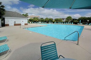 A swimming pool with lounge chairs and a covered area. - Palmy Days at Ironwood 424 (North Myrtle Beach)