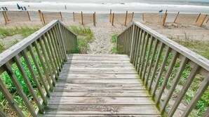 A wooden staircase leading to a beach with a sandy path. - Cozy Beach Rendezvous at The Palace Resort (Myrtle Beach)
