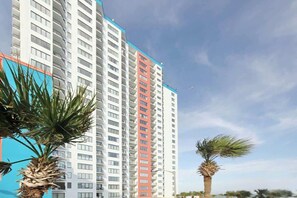 A high-rise building with multiple floors, balconies, and a clear sky. - Cozy Beach Rendezvous at The Palace Resort (Myrtle Beach)
