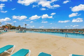 A pool area with lounge chairs and a clear sky. - Myrtle Shores Retreat (Myrtle Beach)