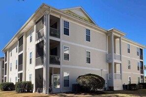 A multi-story building with balconies and a flat roof. - Golfside Escape | River Oaks Sixty-One M (Myrtle Beach)