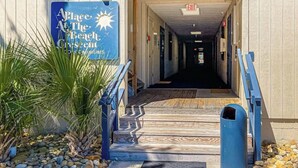 A building entrance with a sign reading 'Place at the Beach' and a number '405' above it. - Beach Happy Place Retreat (North Myrtle Beach)