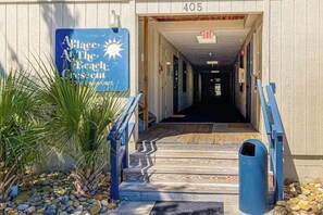 A building entrance with a sign reading 'Place at the Beach' and a number '405' above it. - Beach Happy Place Retreat (North Myrtle Beach)
