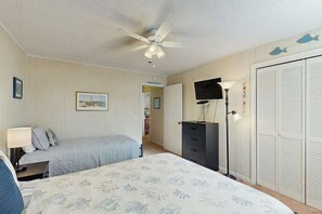 A bedroom with a bed, a desk, a dresser, a ceiling fan, and a wardrobe. - Beach Happy Place Retreat (North Myrtle Beach)
