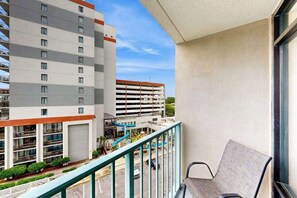 A balcony with a view of a multi-story building, a parking garage, and a water slide. - Sand Dunes Resort 2647 (Myrtle Beach)