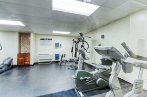 A gym with exercise equipment, a bench, and a wall-mounted sign. - Sand Dunes Resort 2647 (Myrtle Beach)