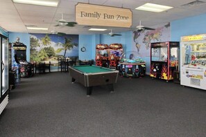 A family fun zone with a pool table, arcade games, and a world map mural. - Coffee with a View Retreat (Myrtle Beach)