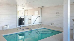 A swimming pool with a white fence, a pool ladder, and a 'NO DIVING' sign on the wall. - Pointe Marsh Unit 2414 (North Myrtle Beach)