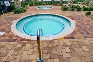 A swimming pool with a tiled edge and a metal handrail. - Sunrise at the Beach (Myrtle Beach)