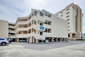 A multi-story parking garage with a sign for 'Palmetto Suites.' - Palmetto Dunes Unit 303 (North Myrtle Beach)